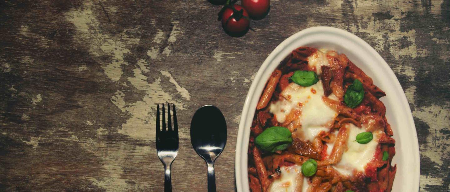 Mouth watering vegetarian pasta bake with rich tomato sauce and cheese toppings